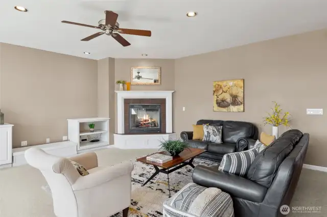 This family room boasts an elevated gas fireplace with a chic white mantle that’s perfect for those cozy movie nights or catching up over a glass of wine. The ceiling fan adds a touch of elegance while ensuring year-round comfort—thanks to the efficient heat pump for cool A/C during the summer. And let’s talk about style: there’s a carpet allowance in place, so you can choose the perfect flooring to match your vision. This space isn’t just about warmth; it’s about creating memories!