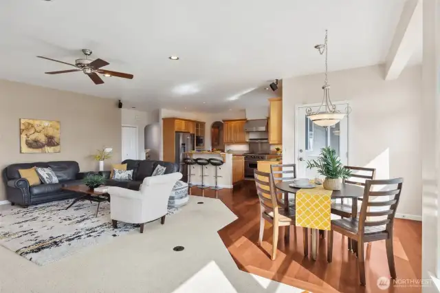 The open layout lets you keep the conversation flowing as you prepare meals. The single door with an upper window invites light and offers easy access to the backyard patio. With a stylish island boasting an additional sink and chic hickory cabinetry, you'll love how this kitchen blends style with practicality.