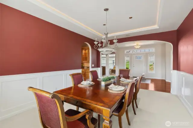 This formal dining room, perfectly positioned across from the entry foyer, boasts elegant arched doorways that seamlessly connect to the butler's pantry—talk about convenient!