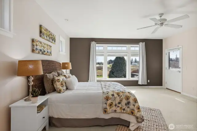Step into this expansive primary suite where comfort meets style! Featuring a ceiling fan for a gentle breeze, this big room includes a separate door that opens directly to your backyard for easy hot tub access—talk about luxury! The massive picture window, complemented by upper accent paneled details, floods the space with natural light. And with room for a lovely seating area, it’s perfect for lounging or enjoying quiet moments. Don’t forget the $10,000 carpet allowance to make it truly yours. Your dream suite awaits!