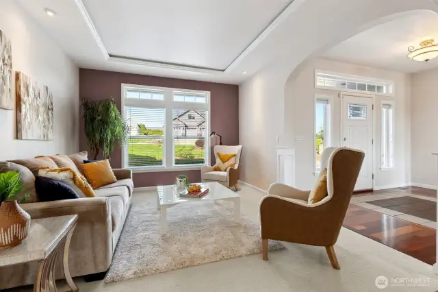This sitting area or formal Living Room/second den area sets the perfect tone for your home! With its stunning LED-lit tray ceiling and towering floor-to-ceiling double portrait windows, you’ll bask in natural light while enjoying views of the front yard and driveway. The wide-slat blinds offer both style and privacy, creating a cozy spot to relax with a book or catch up on emails. It’s all about comfort and elegance right from the entry!