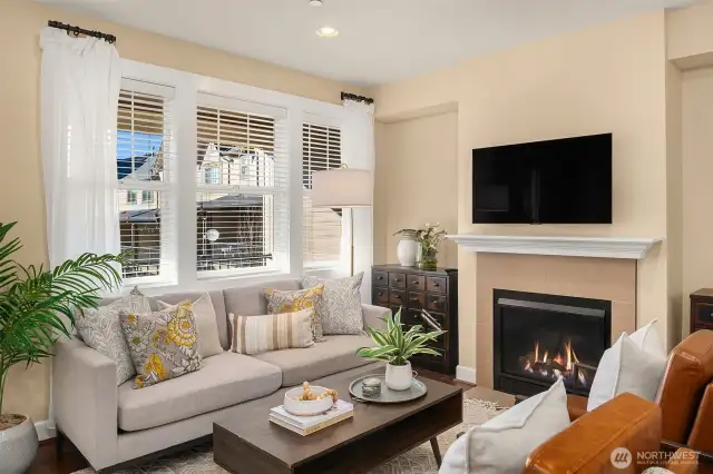 Enjoy the cozy gas fireplace in your living room. This picture window floods the space with tons of natural light.