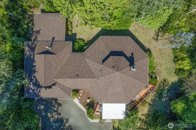 Nestled in verdant established landscaping, new roof in 2020