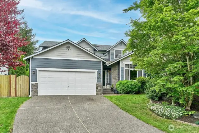 Welcome to your charming and beautifully maintained home! This stunning two-story features eye-catching curb appeal with fresh paint, stone accents, and lush landscaping. A spacious driveway and inviting entryway make a perfect first impression.
