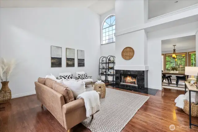 Soaring Vaulted ceilings with rich hardwood floors and wood-burning fireplace.