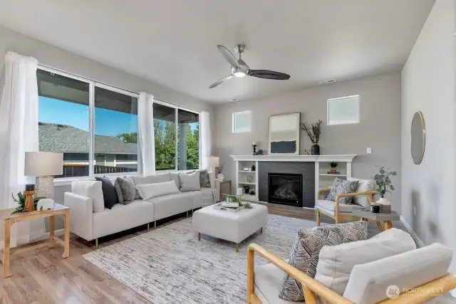 Smartly Lit, Naturally Bright – Large windows and intelligent lighting design make this living room both warm and functional.