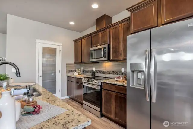 A different perspective showcasing the kitchen’s seamless integration with living and dining areas, perfect for entertaining or family gatherings.