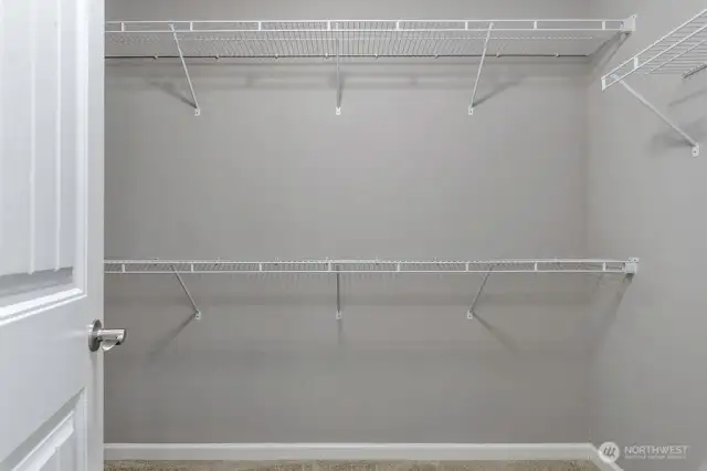 Primary Walk-In Closet – Generous storage with and hanging space.