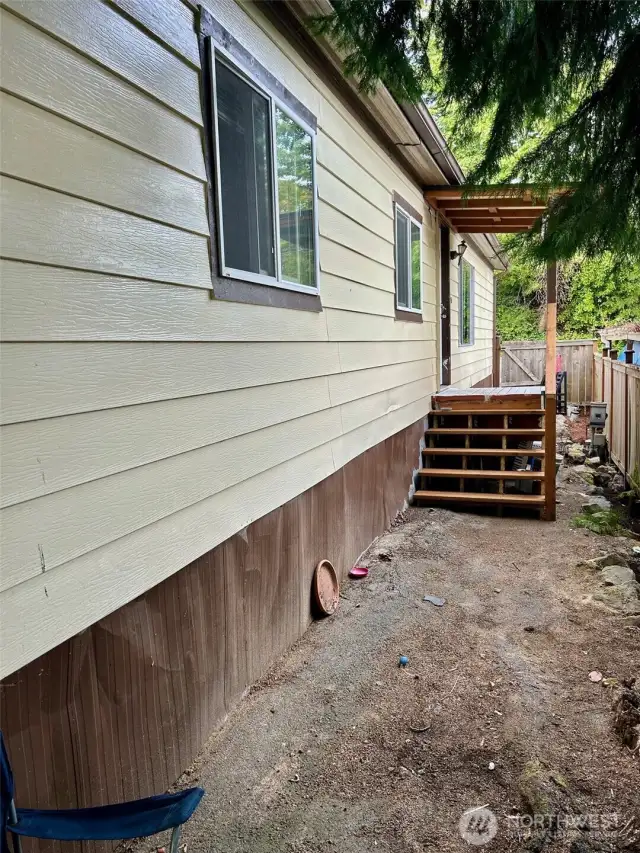Front of home with new steps. New ramp on other side of porch.