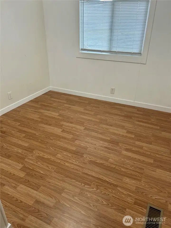 2nd bedroom with new flooring and moulding