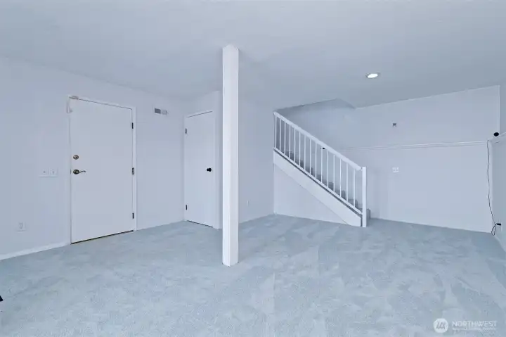 The downstairs rec room with under-stair storage.