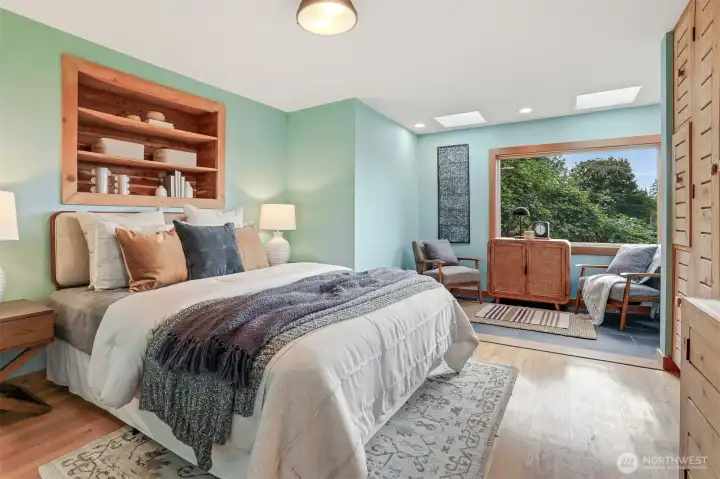 Main floor bedroom with hardwood floors, sunroom addition (skylights, Anderson windows, heated stone floors - $80,000 project), custom cedar wood bump out shelves and armoire.