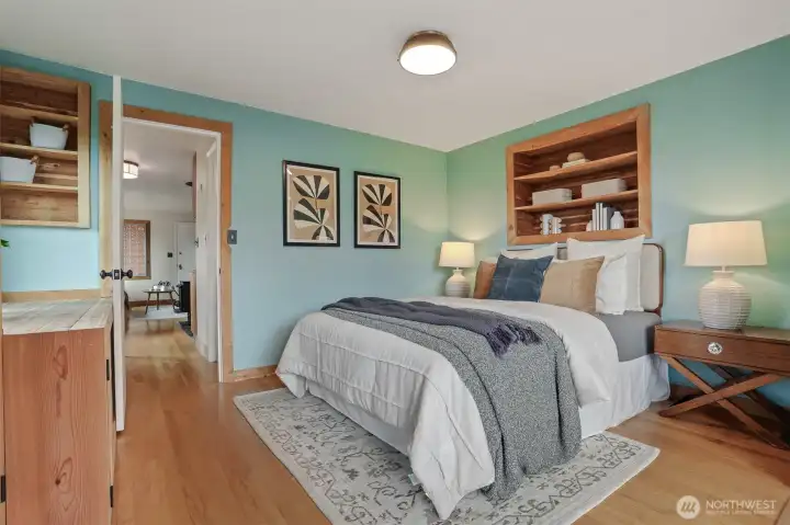 Main floor bedroom with hardwood floors, sunroom addition (skylights, Anderson windows, heated stone floors - $80,000 project), custom cedar wood bump out shelves and armoire.