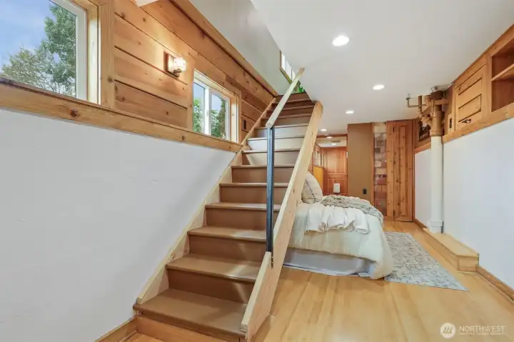 Lower level multi purpose living area:  office, bedroom, family room, etc.  Features:  bamboo floors, cedar built in storage and closet. Has a separate entry and 3/4 bathroom.