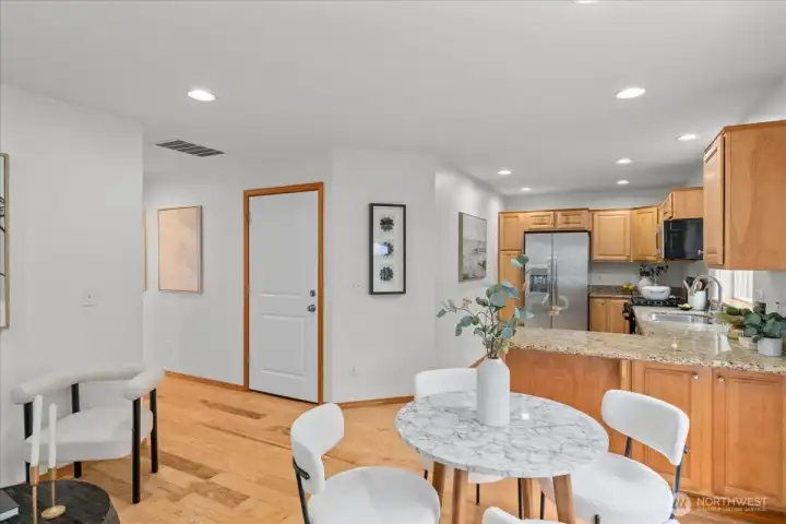 Open kitchen with granite countertops and breakfast bar overlooking the dining area. Layout connects easily to the main living space.