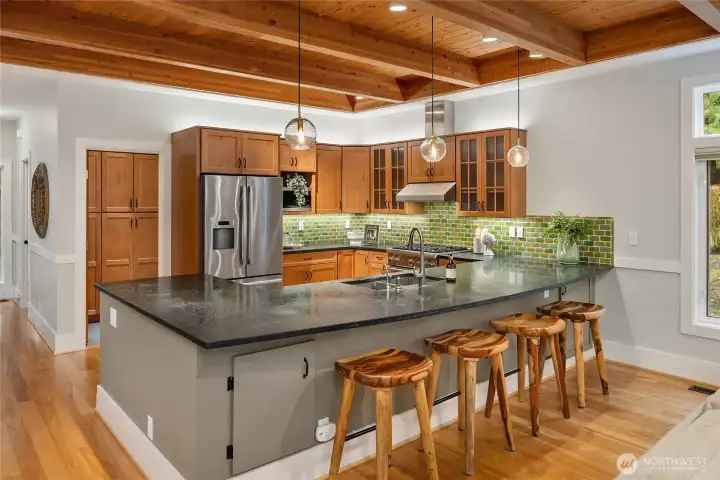 The kitchen is a cook's dream with soapstone countertops and custom cabinetry.