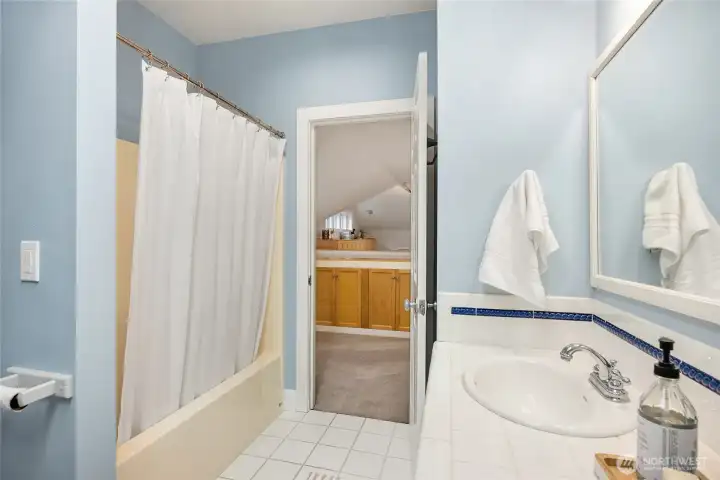 The upper bathroom has a tub and shower.