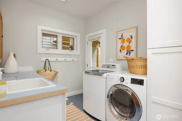The mudroom and laundry room with side entrance right by the detached garage.