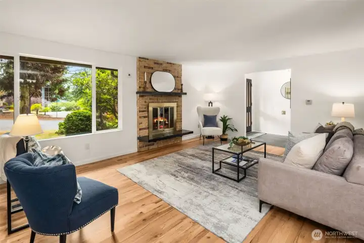 Sun-filled living room anchored by a classic brick fireplace.