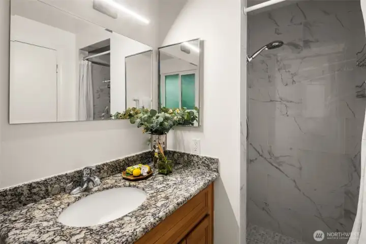 Updated primary bath featuring a beautifully refreshed shower.