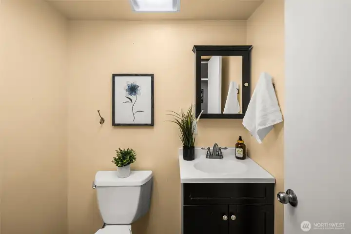 Convenient lower-level powder room serving guests and entertaining space