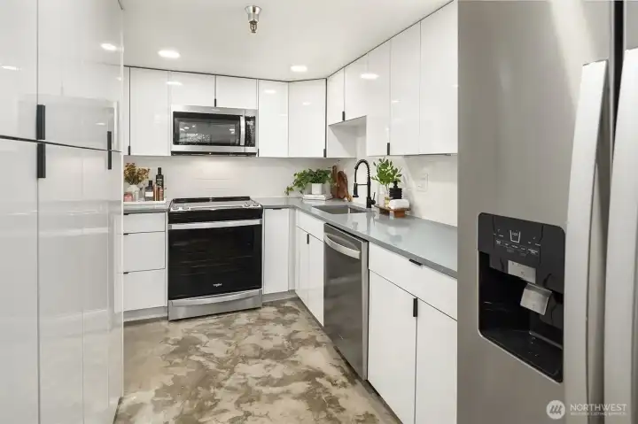 Generous storage throughout, quartz slab countertops, and stainless steel appliances.