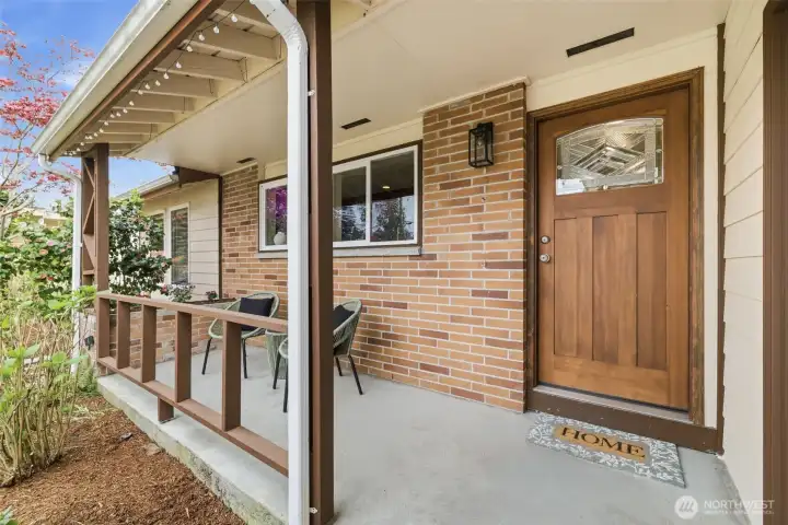 Covered front porch with inviting entry and sitting area