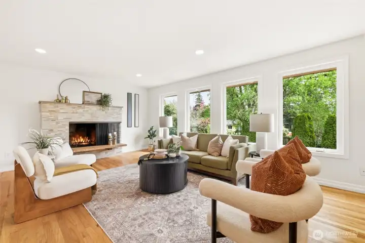 Light and bright living room with large windows and fireplace