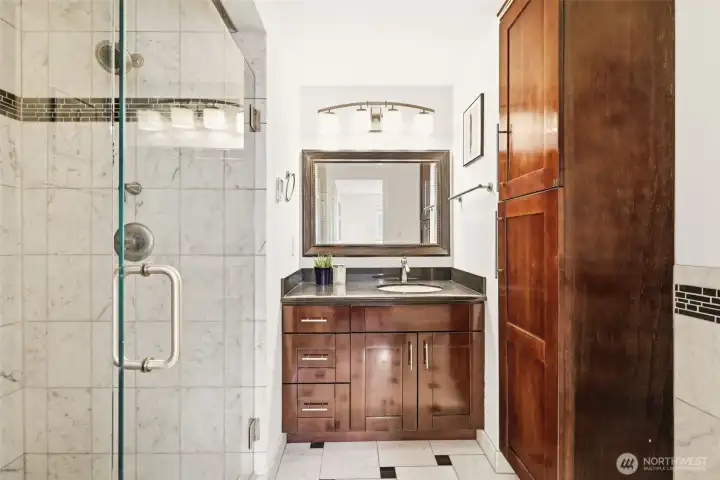 Main floor primary bath with dual vanity and step-in shower