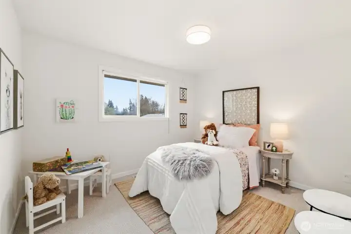 Main floor bedroom 3 with bright window and comfortable layout