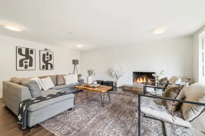 Spacious lower level living room with fireplace and flexible living space