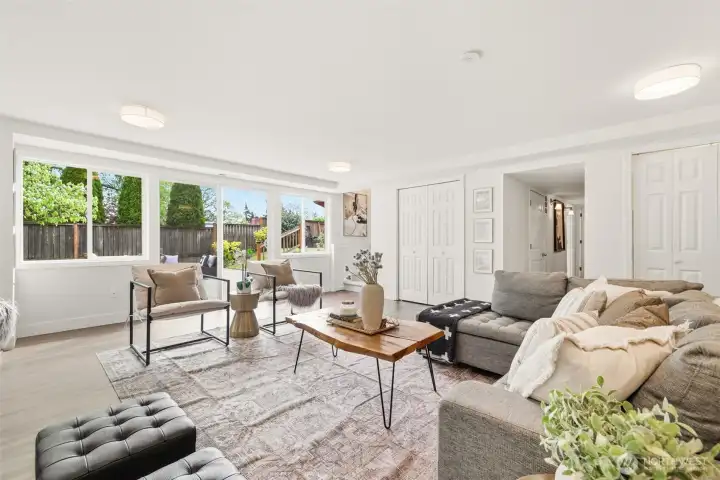 Large lower level living area with patio access and abundant natural light