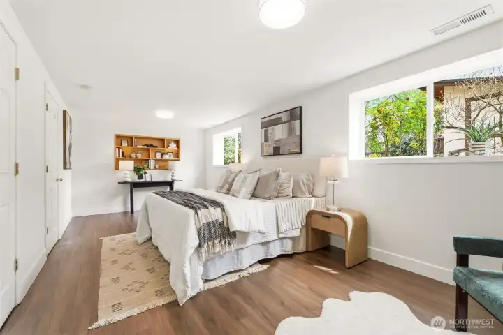 4th bedroom on lower level with en suite access, wood floors, and flexible use