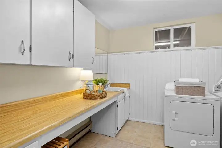 Large folding counter in 3/4 bath laundry combination. Acts as a mud room.