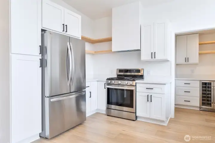 Kitchen w\ new gas stove and double door refrigerator