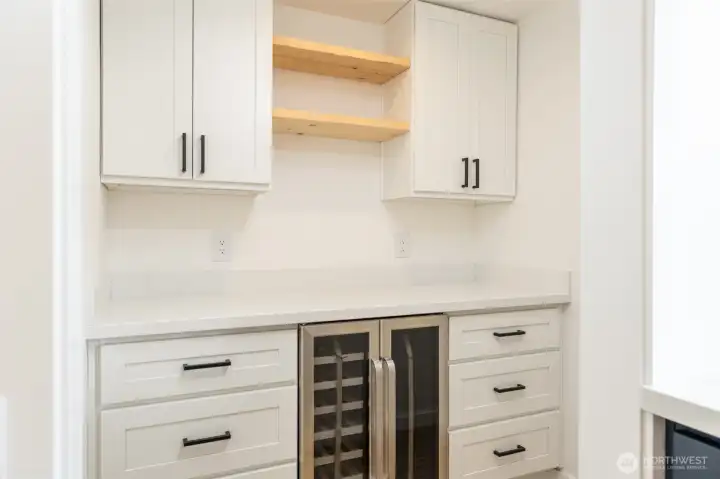 Walk in pantry with a wine and beverage cooler and dedicated power outlets