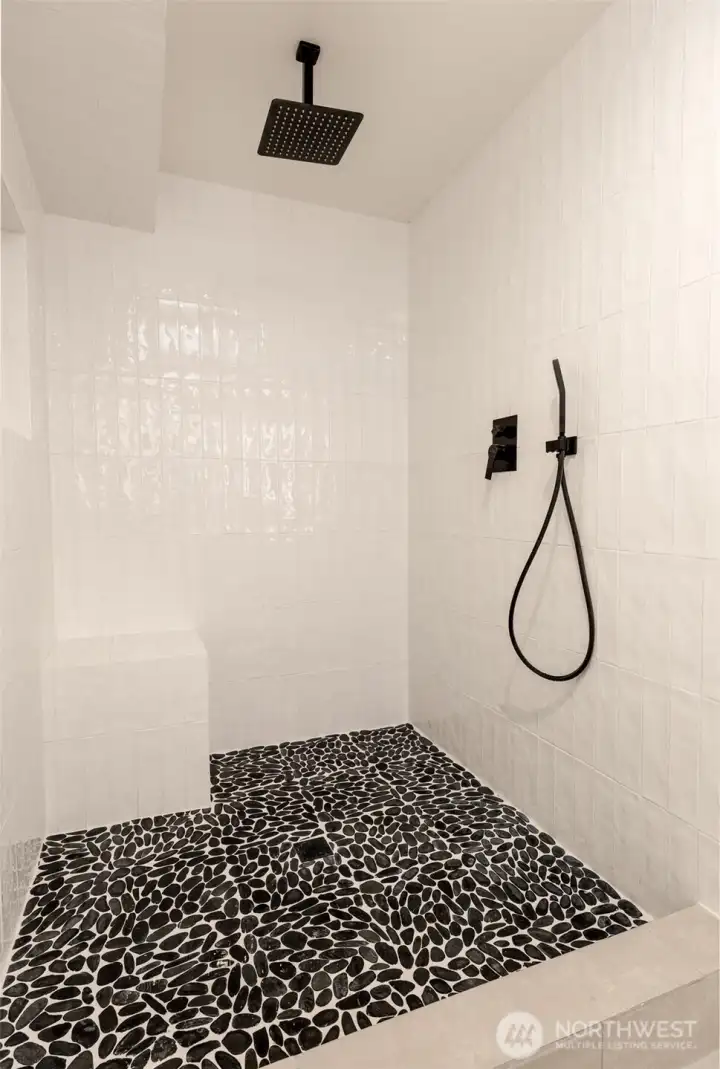 Oversized tile shower w\ overhead waterfall shower head and built in seating