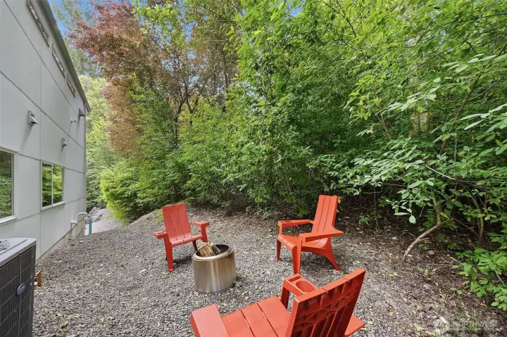 Fire pit area behind the house adjacent to the Burke Gillman Trail Fire pit area behind the house adjacent to the Burke Gillman Trail