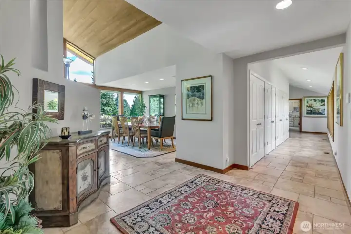 Tile floors and spacious hallway with abundant storage.