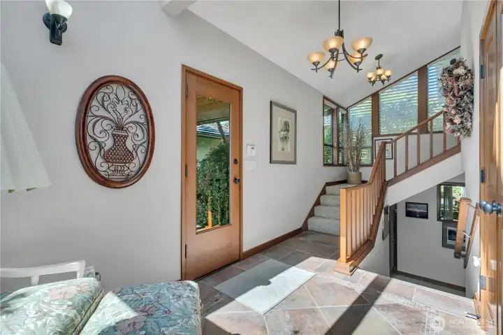 Stairs leading to the garage, sunroom & basement.