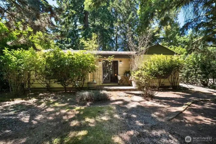 Front yard and driveway entry to the right.