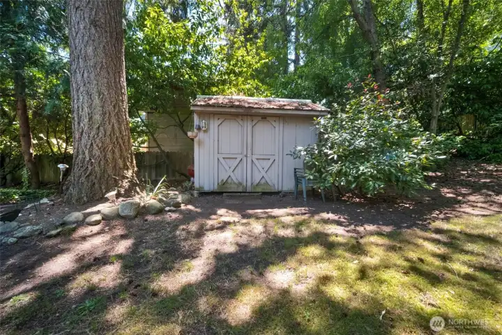 Large shed for garden tools and extra storage.