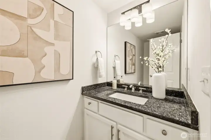 A half bathroom sits just around the corner from the main floor bedroom, with opportunity to be expanded into a 3/4 bath for a multigenerational living setup A half bathroom sits just around the corner from the main floor bedroom, with opportunity to be expanded into a 3/4 bath for a multigenerational living setup