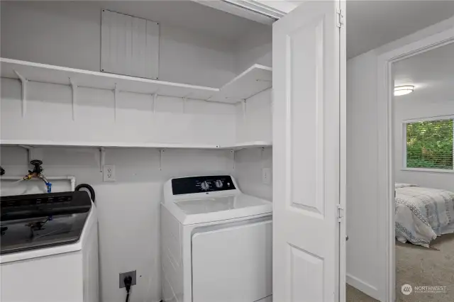 Utility room with included washer and dryer.