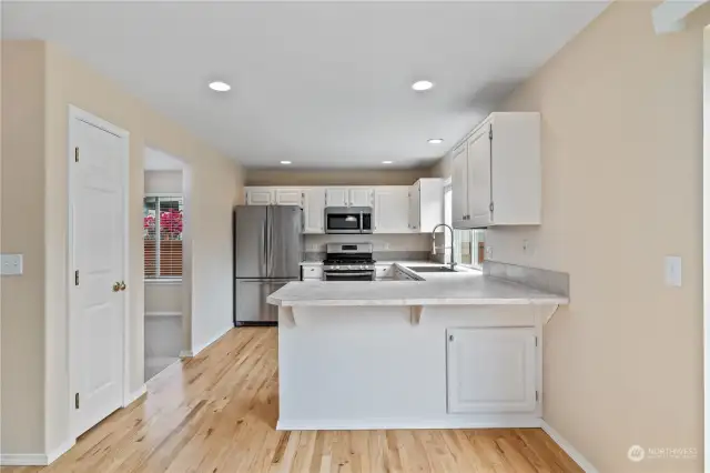 The Kitchen offers an abundance a cabinetry, counter top space and seating at the breakfast bar. The door to the left is the Pantry, offering even more storage