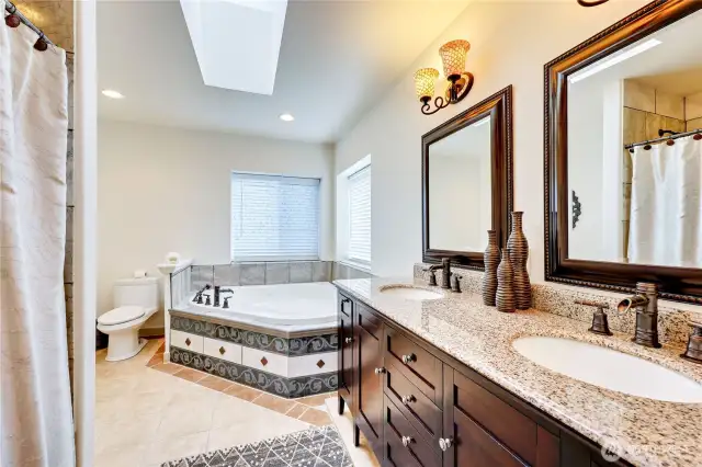 The full spa-inspired bath incudes a double vanity with granite slab countertop, jetted tub.
