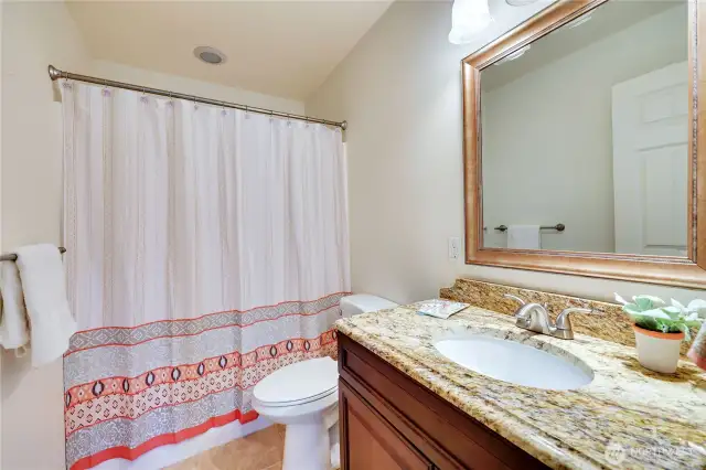 The full bath on this level is between the two bedrooms.