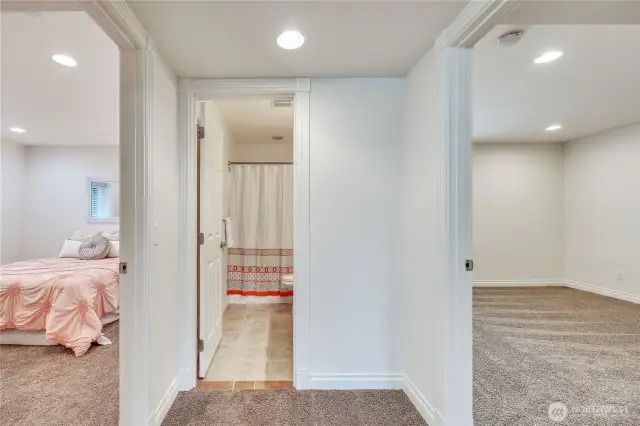 The hallway off the large rec room on the ground floor, there are 2 bedrooms with a full bath in between.