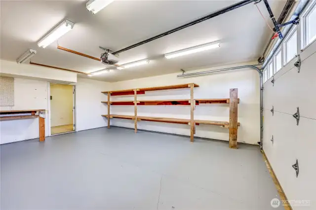 The large 2 car garage- there is tons of built in shelving here, plus a utility room beyond that door with lots more storage.