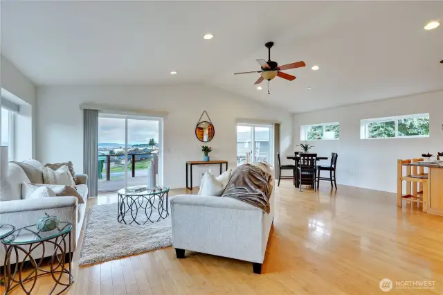 The main living areas and primary are on the upper level to take full advantage of the sweeping views. This great room is surrounded by windows, so it enjoys great natural light, with 2 wide glass sliders to the view deck.